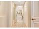 Clean hallway with beige carpeting and access to bathroom at 5306 Manorwood Dr # 2A, Sarasota, FL 34235