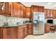 Kitchen with granite countertops, stainless steel appliances, and wood cabinets at 5306 Manorwood Dr # 2A, Sarasota, FL 34235