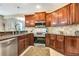 Kitchen with granite countertops, stainless steel appliances, and wood cabinets at 5306 Manorwood Dr # 2A, Sarasota, FL 34235
