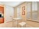 Bright kitchen nook with white table and chairs, and built-in cabinets at 5306 Manorwood Dr # 2A, Sarasota, FL 34235