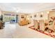 Open living room with sliding doors to balcony and view of patio furniture at 5306 Manorwood Dr # 2A, Sarasota, FL 34235