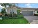 One-story home with gray siding, landscaping, and a two-car garage at 5433 Hope Sound Cir, Sarasota, FL 34238