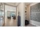 Hallway with tile floors, art niches, and views into the living room at 5433 Hope Sound Cir, Sarasota, FL 34238