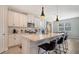 Modern kitchen with white cabinets, quartz countertops, and island at 5433 Hope Sound Cir, Sarasota, FL 34238