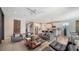 Open concept living room with gray sofas and a large TV at 5433 Hope Sound Cir, Sarasota, FL 34238
