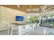 Outdoor bar with seating and large TV; perfect for entertaining at 5433 Hope Sound Cir, Sarasota, FL 34238