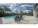Backyard pool with screen enclosure, spa, and comfortable lounge chairs at 5433 Hope Sound Cir, Sarasota, FL 34238