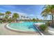 Community pool surrounded by lush landscaping and palm trees, offering a relaxing atmosphere at 5433 Hope Sound Cir, Sarasota, FL 34238