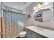 Clean bathroom with a marble vanity and floral shower curtain at 585 Purdy St, Englewood, FL 34223