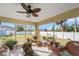 Relaxing screened porch with wicker furniture and potted plants at 585 Purdy St, Englewood, FL 34223