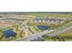 Community aerial view featuring beautiful single-Gathering homes, picturesque lakes, and manicured streets at 6005 Mesa Gln, Bradenton, FL 34203