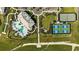 Aerial view showcasing the community's resort-style pool, clubhouse, tennis and pickleball courts, and well-manicured landscaping at 6005 Mesa Gln, Bradenton, FL 34203