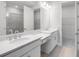 Primary bathroom featuring dual sinks, granite countertops and glass-enclosed shower at 6005 Mesa Gln, Bradenton, FL 34203