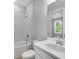 This bathroom has a vanity sink, white cabinets, and a shower and tub combo at 6005 Mesa Gln, Bradenton, FL 34203