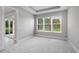 Cozy bedroom featuring large windows, plush gray carpet, and lots of natural light at 6005 Mesa Gln, Bradenton, FL 34203