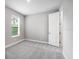 This bedroom has neutral walls, plush carpeting, and a window for natural light at 6005 Mesa Gln, Bradenton, FL 34203
