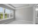 Bright bedroom featuring large window with blinds and walk-in bathroom at 6005 Mesa Gln, Bradenton, FL 34203