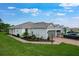 Single Gathering home with a two-car garage, beautiful landscaping, and a brick driveway at 6005 Mesa Gln, Bradenton, FL 34203