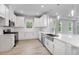 This kitchen has white cabinets, stainless appliances, and a large undermount sink at 6005 Mesa Gln, Bradenton, FL 34203