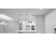 This home has an open concept kitchen and living area with pendant lights over the island at 6005 Mesa Gln, Bradenton, FL 34203
