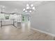 This open concept area has a modern chandelier and views of the kitchen at 6005 Mesa Gln, Bradenton, FL 34203
