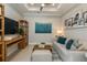 Home office with large TV, sofa, and decorative shelves at 6005 Mesa Gln, Bradenton, FL 34203