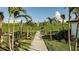 Scenic walking path lined with palm trees and lush landscaping, offering a tranquil outdoor experience at 6005 Mesa Gln, Bradenton, FL 34203