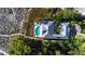 Stunning aerial view of a luxury home with pool, lush landscaping, and beach access at 6061 Gulf Of Mexico Dr, Longboat Key, FL 34228