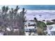 Aerial view showcasing beachside property with lush trees and white sand beach at 6061 Gulf Of Mexico Dr, Longboat Key, FL 34228