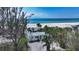 Beach house surrounded by palm trees with white sand beach at 6061 Gulf Of Mexico Dr, Longboat Key, FL 34228