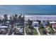 Aerial view showing home near white sand beach with clear, blue water at 6061 Gulf Of Mexico Dr, Longboat Key, FL 34228
