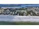 Aerial view of waterfront homes on a pristine white sand beach at 6061 Gulf Of Mexico Dr, Longboat Key, FL 34228