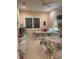 Bright bedroom featuring two twin beds with floral bedding, and white wicker furniture at 6061 Gulf Of Mexico Dr, Longboat Key, FL 34228