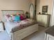 Comfortable bedroom with a large bed, colorful floral bedding, and a surfboard at 6061 Gulf Of Mexico Dr, Longboat Key, FL 34228