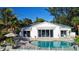 Beautiful backyard with pool, patio and tropical landscaping at 6061 Gulf Of Mexico Dr, Longboat Key, FL 34228