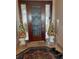 Elegant front door with decorative glass inlay and fruit basket decorations at 6061 Gulf Of Mexico Dr, Longboat Key, FL 34228