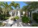 Landscaped entry with tropical plants and a walkway leading to the home's entrance at 6061 Gulf Of Mexico Dr, Longboat Key, FL 34228