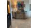 Hallway with a stylish sideboard cabinet with ornate lamps and colorful art at 6061 Gulf Of Mexico Dr, Longboat Key, FL 34228