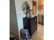 Hallway view with decorative mirror, cabinet and bust statue in well decorated home at 6061 Gulf Of Mexico Dr, Longboat Key, FL 34228
