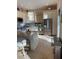 Modern kitchen with stainless steel appliances, marble countertops, and ample cabinet space at 6061 Gulf Of Mexico Dr, Longboat Key, FL 34228