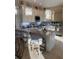 Elegant kitchen with a marble island, modern appliances, and stylish bar stools at 6061 Gulf Of Mexico Dr, Longboat Key, FL 34228