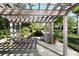 Lovely pergola covered patio, great for relaxing outdoors at 6061 Gulf Of Mexico Dr, Longboat Key, FL 34228