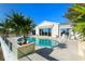 Inviting kidney-shaped pool with a stone deck and glass railing at 6061 Gulf Of Mexico Dr, Longboat Key, FL 34228