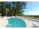 Refreshing pool area with outdoor seating, manicured landscaping, and ocean views at 6061 Gulf Of Mexico Dr, Longboat Key, FL 34228