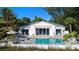 Beautiful backyard featuring a private pool with a clear glass fence offering unobstructed views of the ocean at 6061 Gulf Of Mexico Dr, Longboat Key, FL 34228