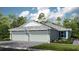 Two-story home with three-car garage and landscaped front yard at 6097 Mesa Gln, Bradenton, FL 34203