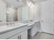 Bathroom features double sink vanity, grey tile floor and large mirror at 6107 Mesa Gln, Bradenton, FL 34203