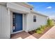 Inviting home showcasing a bright blue front door complemented by neat landscaping and a paved walkway at 6107 Mesa Gln, Bradenton, FL 34203