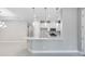 Modern kitchen with stainless steel appliances, white cabinetry, a large island, and pendant lighting at 6107 Mesa Gln, Bradenton, FL 34203