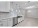 Bright kitchen with stainless steel appliances, a large island, and stylish pendant lights over the countertop at 6107 Mesa Gln, Bradenton, FL 34203